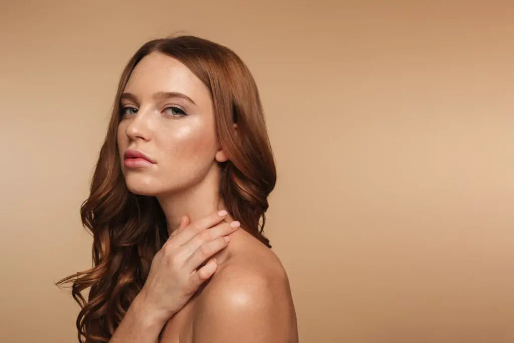 Beauty portrait of calm ginger woman with long hair posing